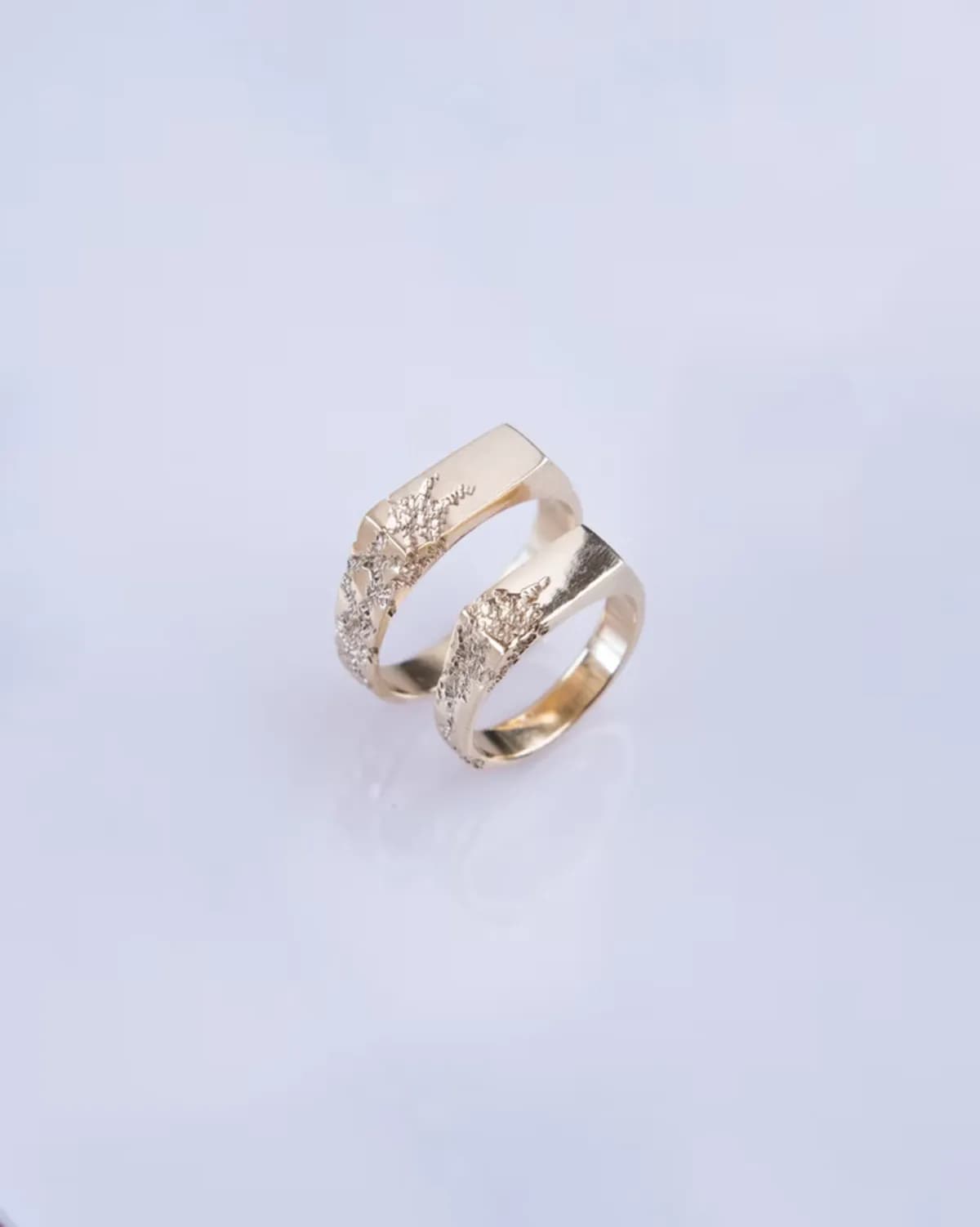 Two handmade gold rings with uneven organic surfaces